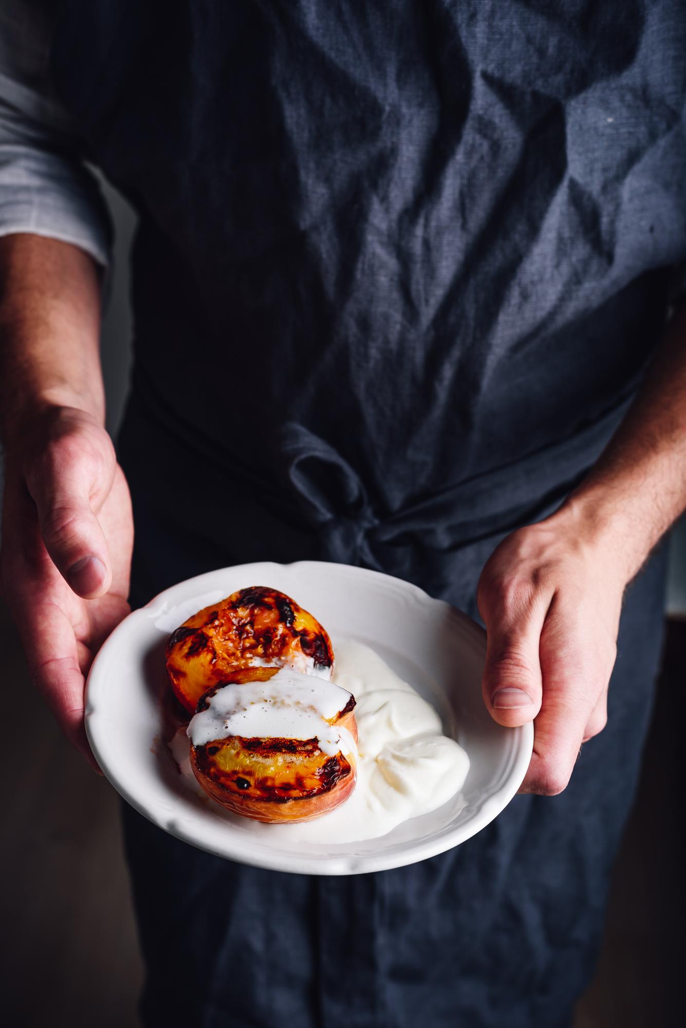 Instructor plating a composed dish in a calm studio